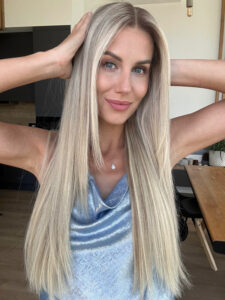 Woman wearing a long wig in color "Julianne Hough"